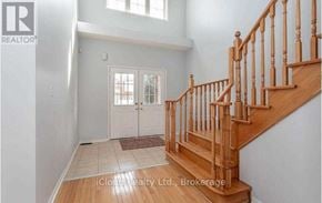 Brampton (Credit Valley) apartment for rent - A wooden staircase with a carpeted landing.