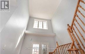 Brampton (Credit Valley) apartment for rent - A wooden staircase leads up to a second floor landing with a window.