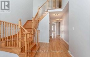 Brampton (Credit Valley) apartment for rent - A wooden staircase in a house with a brokerage logo.