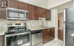 Mississauga (City Centre) condo for rent - A kitchen with brown cabinets and stainless steel appliances.