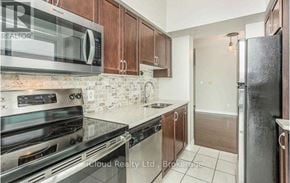 Mississauga (City Centre) condo for rent - A kitchen with a stove top oven, microwave, and refrigerator.