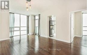 Mississauga (City Centre) condo for rent - A well-lit room with a chandelier, large windows, and a wooden floor.
