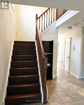London North (North M) apartment for rent - A staircase with a wooden handrail and dark brown steps.