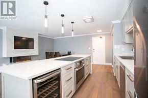 Sault Ste. Marie condo for rent - A modern kitchen with white appliances and wooden floors.