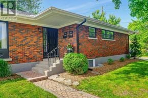 Ottawa apartment for rent - A red brick house with a black door and windows.
