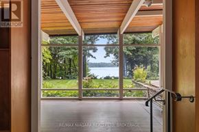 St. Catharines (Martindale Pond) apartment for rent - A view of a lake through a glass door.