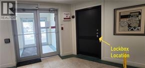 Brantford condo for rent - A hallway with a lockbox located on the right wall.