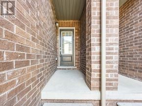 Ajax (Northeast Ajax) townhouse for rent - A brick wall with a doorway leading to a balcony.