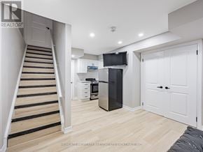 Ajax (Northeast Ajax) townhouse for rent - A modern kitchen with a staircase leading to the upper floor.