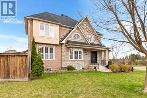 Ajax (Northeast Ajax) apartment for rent - A house with a brown fence and a tree in front.