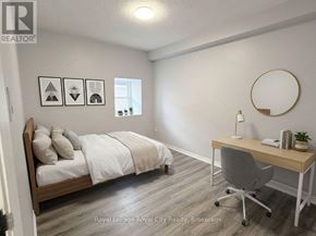 Guelph (Downtown) multi-family for rent - A bedroom with a bed, desk, and chair.