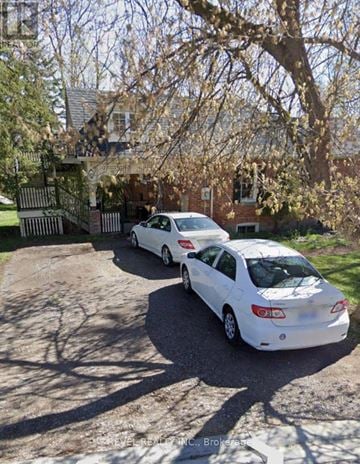 Caledon (Bolton West) apartment for rent - Two white cars parked in front of a house.