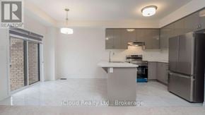 Brantford townhouse for rent - A kitchen with stainless steel appliances and a marble floor.