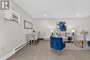St. Catharines (Secord Woods) multi-family for rent - A living room with a blue chair in the center.