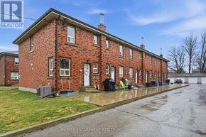 Hamilton (Hampton Heights) townhouse for rent - A red brick house with a white door and windows.