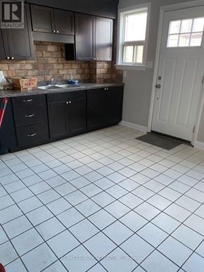 Hamilton (Hampton Heights) townhouse for rent - A kitchen with black cabinets and a white door.