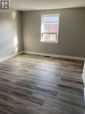 Hamilton (Hampton Heights) townhouse for rent - A room with a window and wooden flooring.