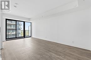 Toronto (Leaside) condo for rent - A spacious room with a view of a building outside through the windows.