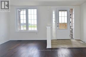 Ajax (Northeast Ajax) townhouse for rent - A room with a white door and a window with a view of a grassy field.