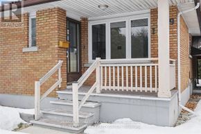 Ottawa apartment for rent - A house with a white porch and a glass door.