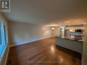 London North (North F) apartment for rent - A spacious room with wooden flooring and a counter in the corner.