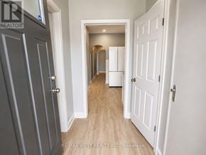 Oshawa (Lakeview) apartment for rent - A hallway with a white door on the right and a grey door on the left.