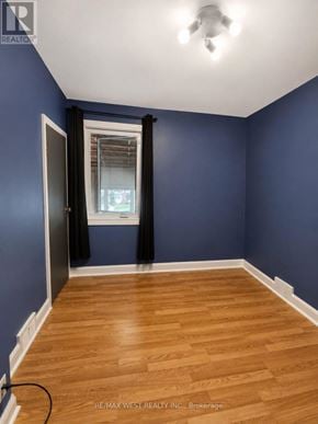 Oshawa (Lakeview) apartment for rent - A room with blue walls and wooden flooring.