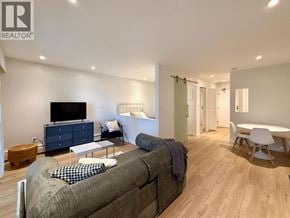 Vancouver apartment for rent - A living room with a grey couch and a television.