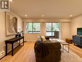 Vancouver apartment for rent - A living room with a couch, a coffee table, and a painting on the wall.
