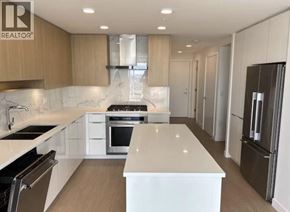 Burnaby apartment for rent - A modern kitchen with a white countertop and stainless steel appliances.