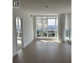 Burnaby apartment for rent - A large empty room with a view of the city.