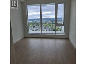 Burnaby apartment for rent - A room with a large window overlooking a cityscape.