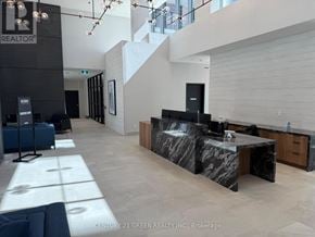 Milton (Tm Timberlea) condo for rent - A modern office space with a reception desk and a staircase.