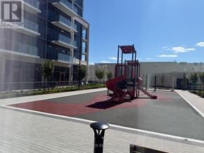Milton (Tm Timberlea) condo for rent - A playground area with a slide and a red and white area in the middle.
