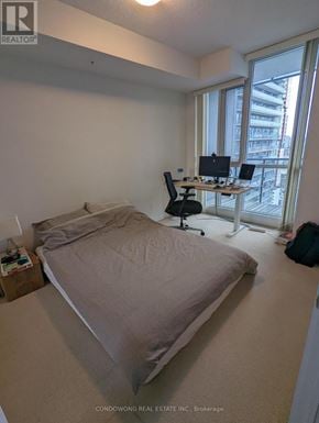 Toronto (Waterfront Communities) condo for rent - A bedroom with a bed, desk, and chair.