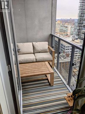Toronto (Waterfront Communities) condo for rent - A balcony with a couch and a table.