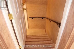 Toronto (Ionview) apartment for rent - A staircase with a metal handrail and wooden steps.