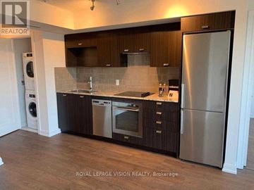 Toronto (Agincourt South-Malvern West) condo for rent - A kitchen with a refrigerator, oven, and washing machine.