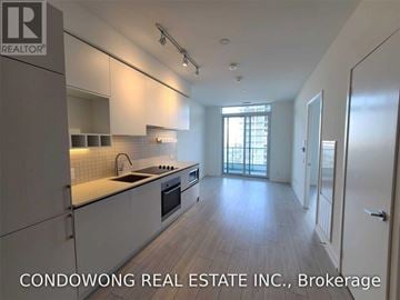 Vaughan (Vaughan Corporate Centre) condo for rent - A modern kitchen with white cabinets and a large window.