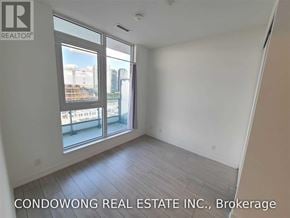 Vaughan (Vaughan Corporate Centre) condo for rent - A room with a large window overlooking a cityscape is for sale by Condowong Real Estate Inc. in Brokerage.