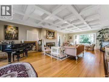 Vancouver apartment for rent - A spacious living room with a grand piano and a large painting on the wall.