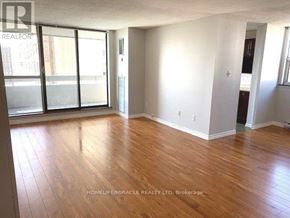 Brampton (Queen Street Corridor) condo for rent - A room with wooden flooring and a sliding glass door.