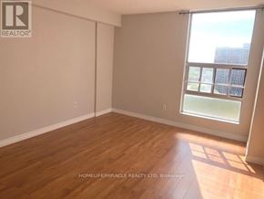 Brampton (Queen Street Corridor) condo for rent - A room with wooden flooring and a large window.