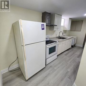 London East (East C) apartment for rent - A white fridge with a purple sticker on it in a kitchen.