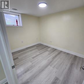 London East (East C) apartment for rent - A room with light wood flooring and a window with a red fire extinguisher on the sill.