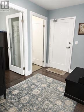 London East (East F) condo for rent - A room with a rug, a piano and a door.