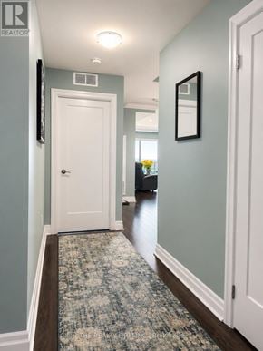 London East (East F) condo for rent - A hallway with a rug and a door.