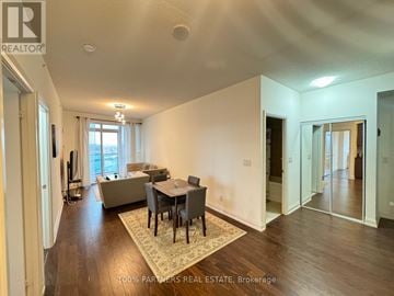 Markham (Thornhill) condo for rent - A spacious living room with a dining table and chairs.