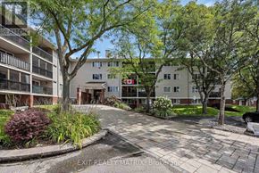Ottawa condo for rent - A residential area with apartment buildings and a paved walkway.