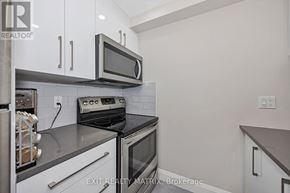 Ottawa condo for rent - A kitchen with a stove top oven and microwave.